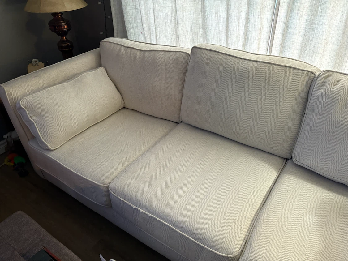 Beige 3 seater sofa with cushions