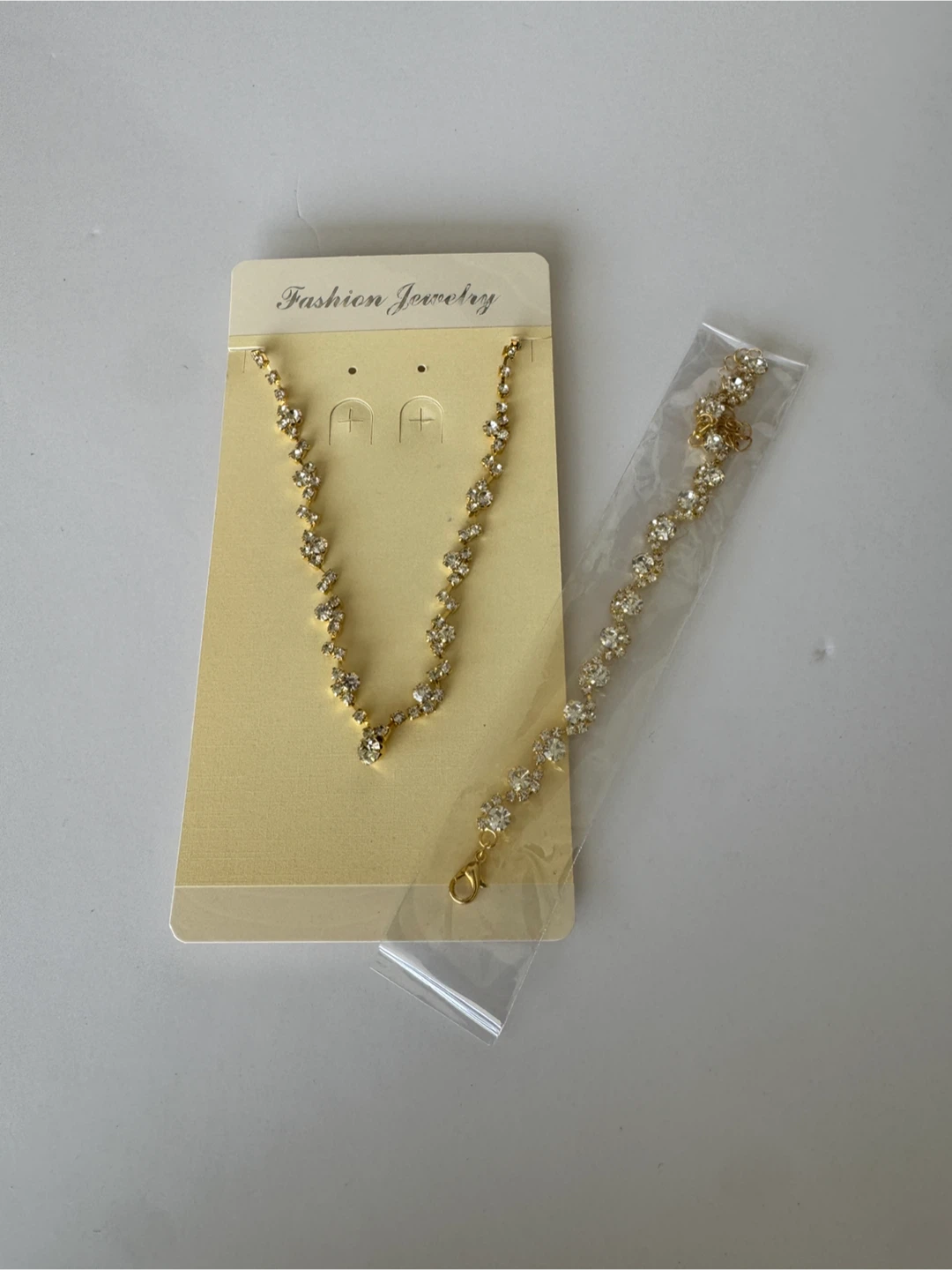 Gold tone rhinestone necklace and bracelet set