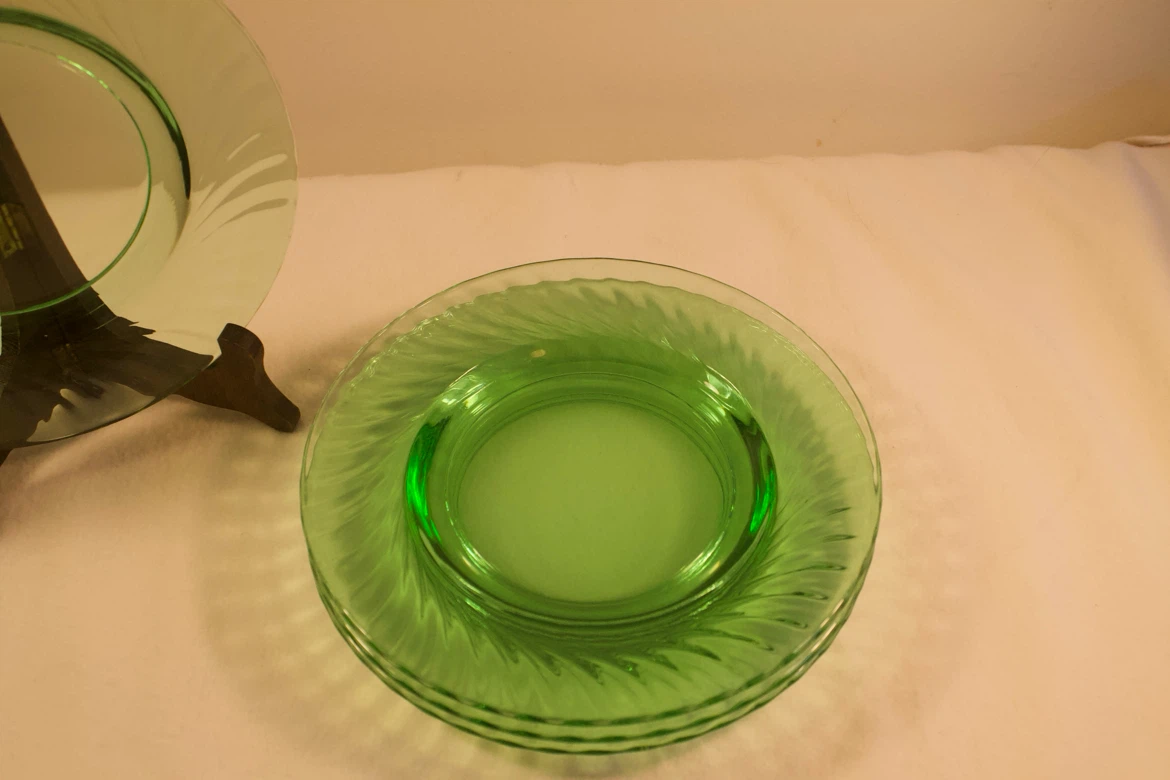 Four Medium Sized Green Glass Plates