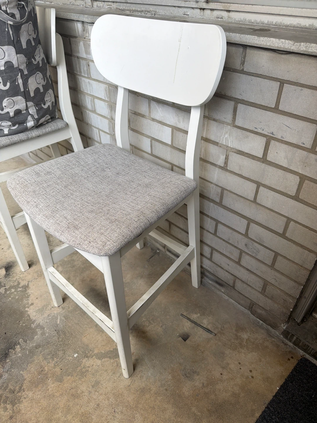 White bar stool with grey fabric seat