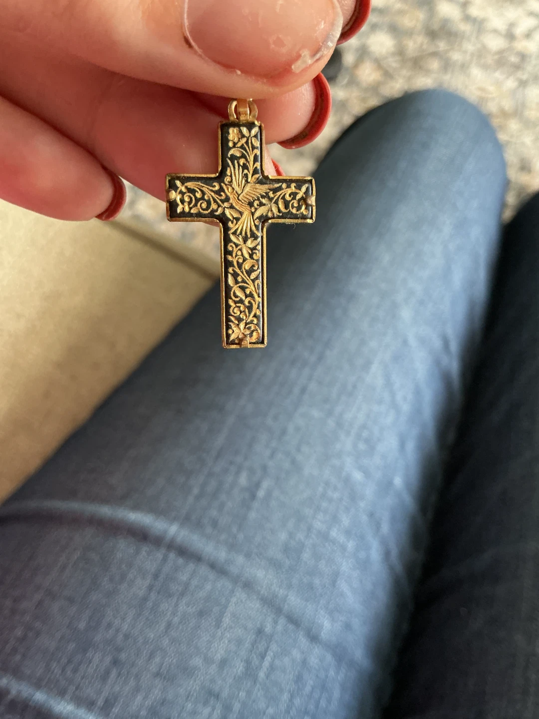 Gold tone cross pendant with bird and floral detail