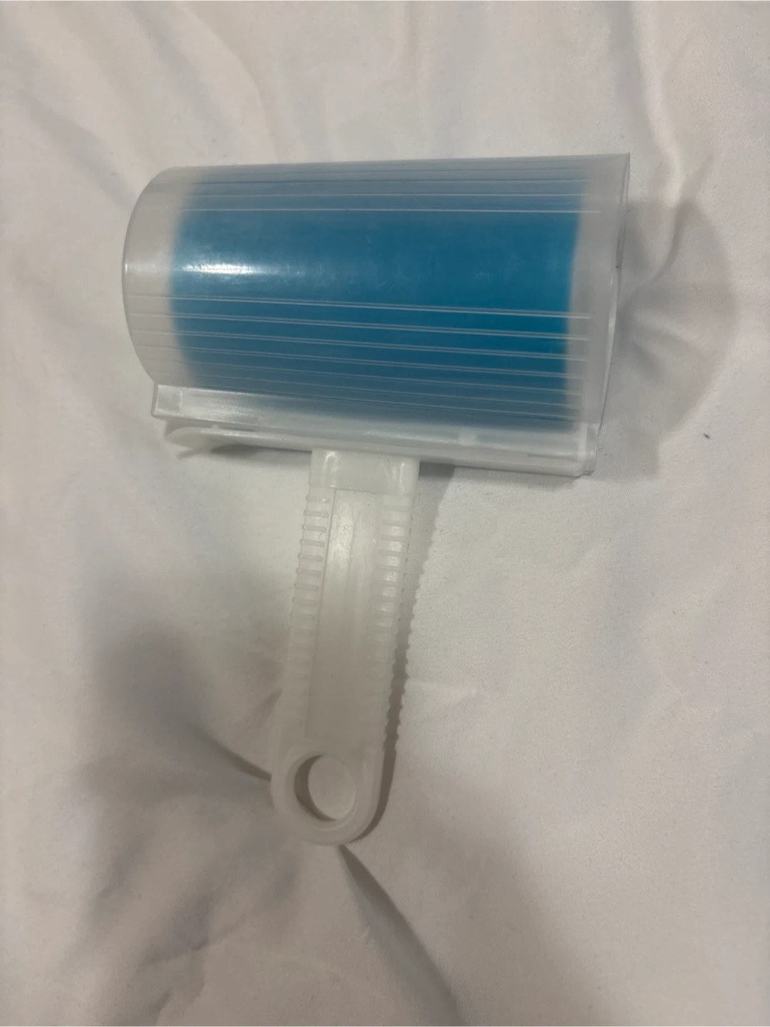 Lint roller with blue sticky surface