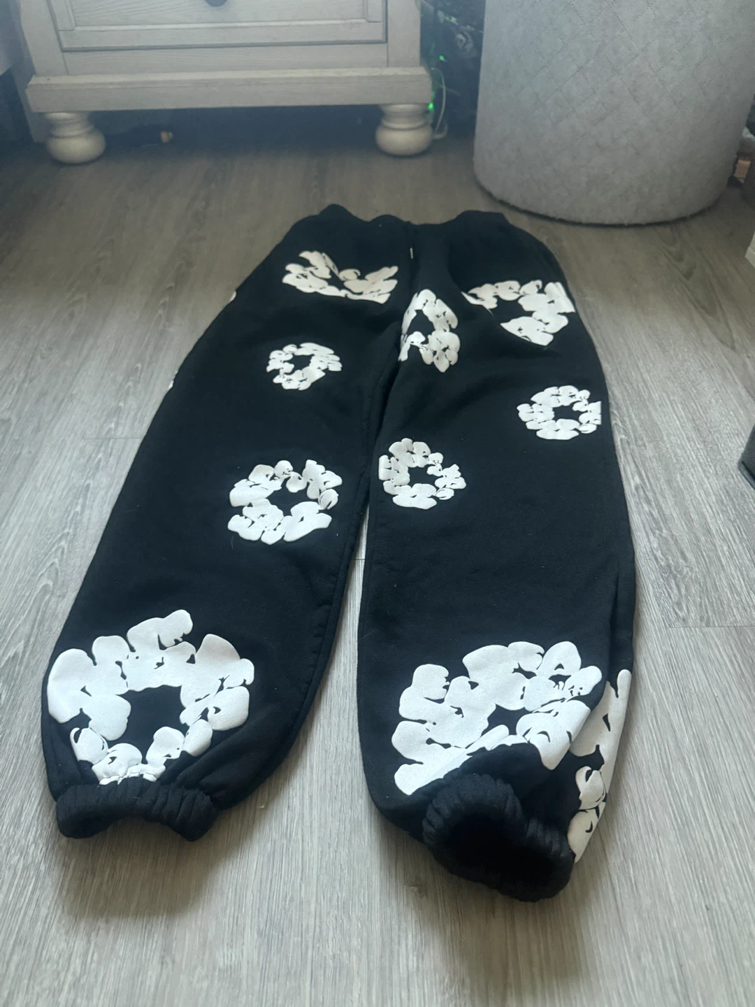 Black sweatpants with white floral print