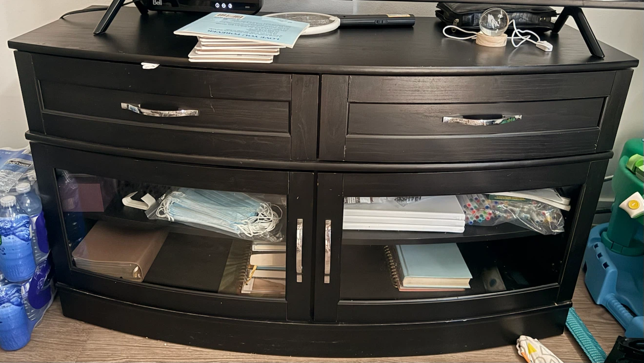 Black wooden TV stand with glass doors