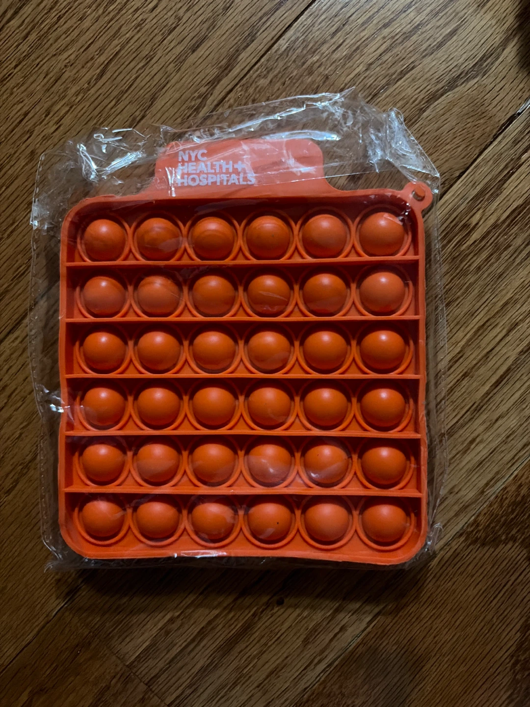 Orange NYC Health + Hospitals Pop It Fidget Toy