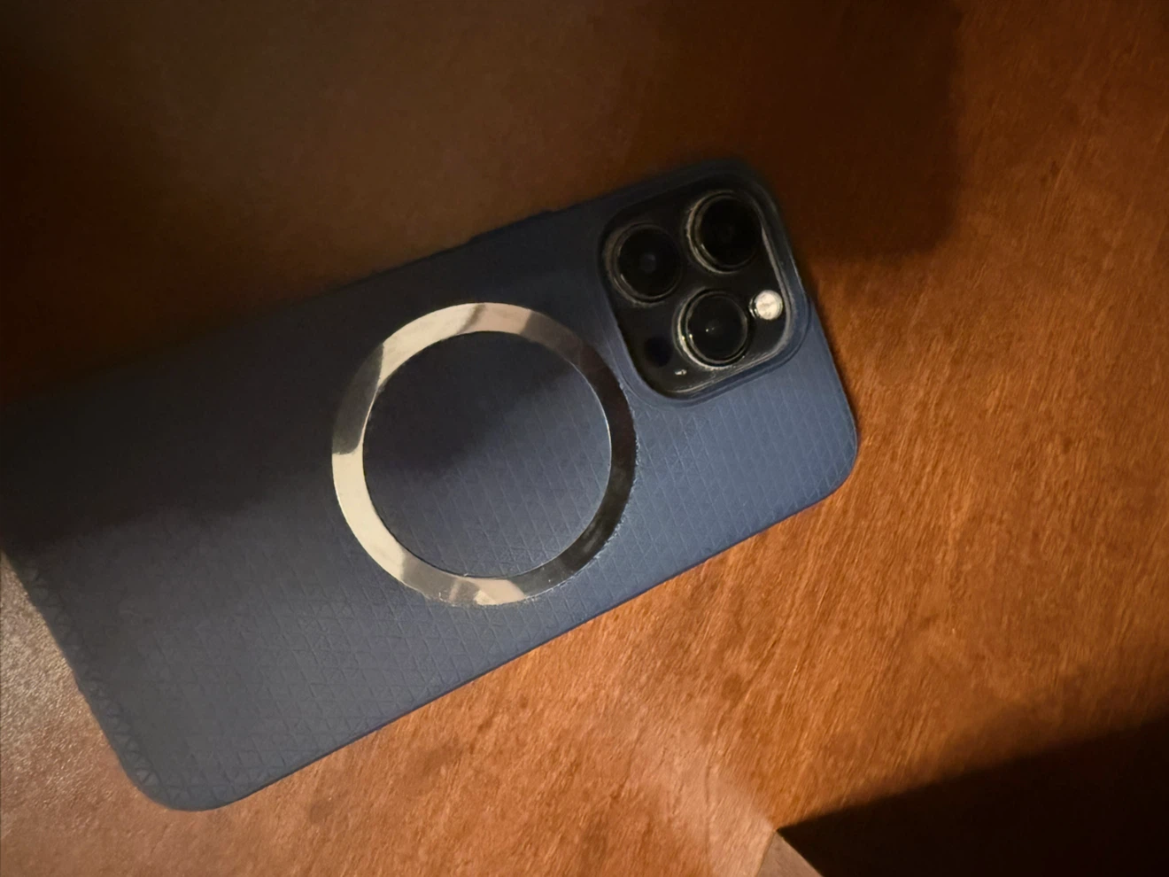 Silver iPhone 13 Pro Max and a phone case with MagSafe Ring