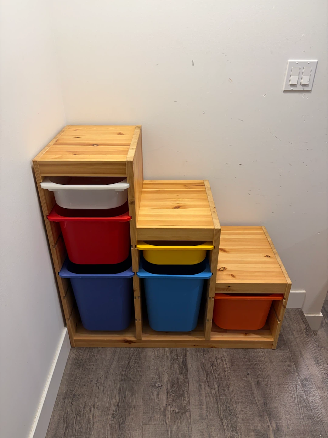 IKEA cabinet stair shape with colourful bins
