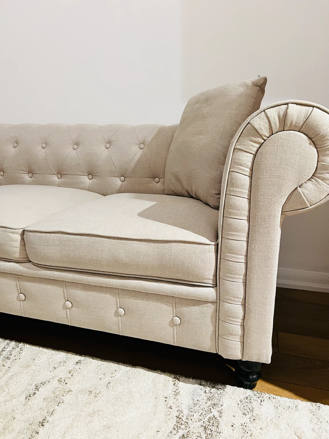 Beige tufted chesterfield sofa