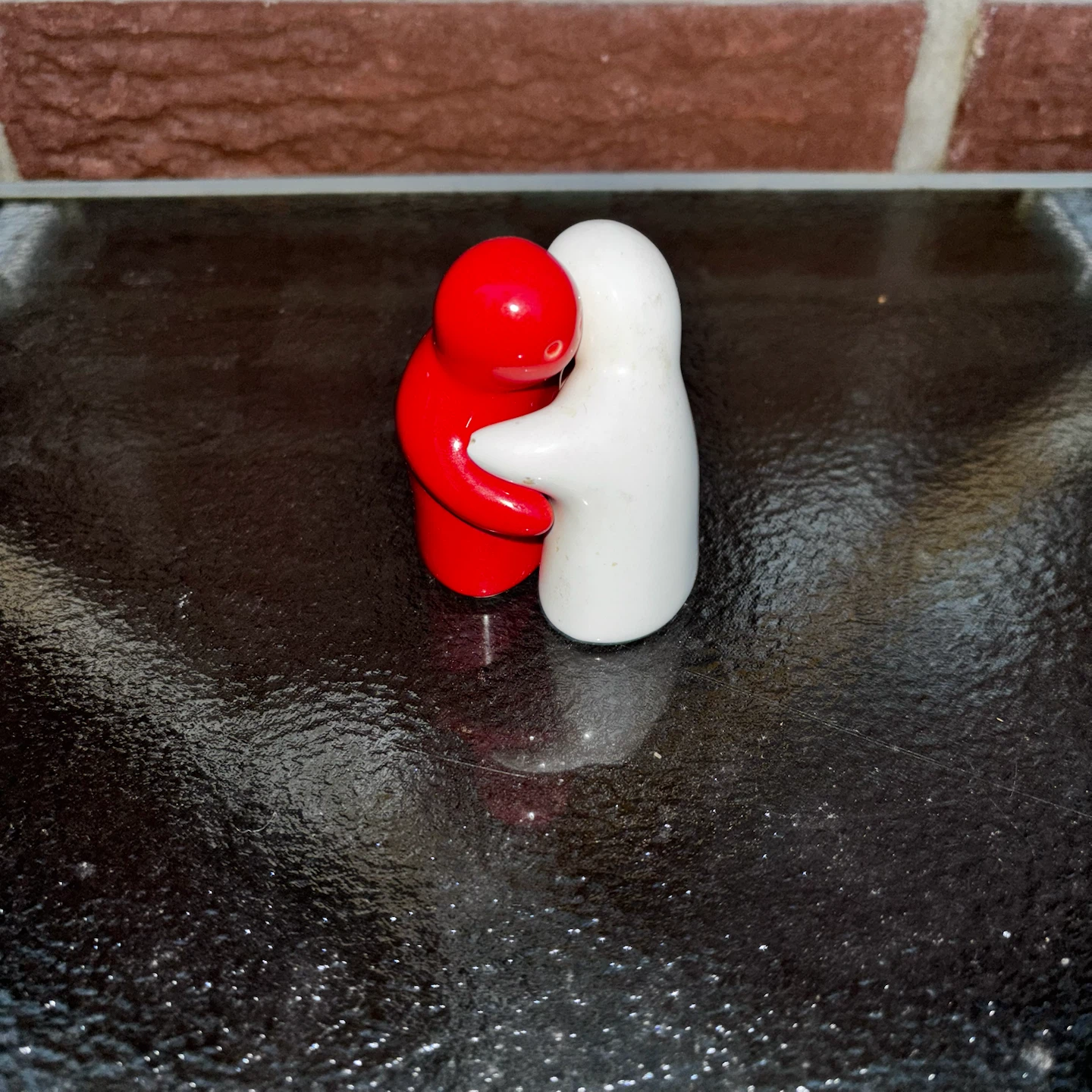 Red and White Hugging People Salt and Pepper Shakers