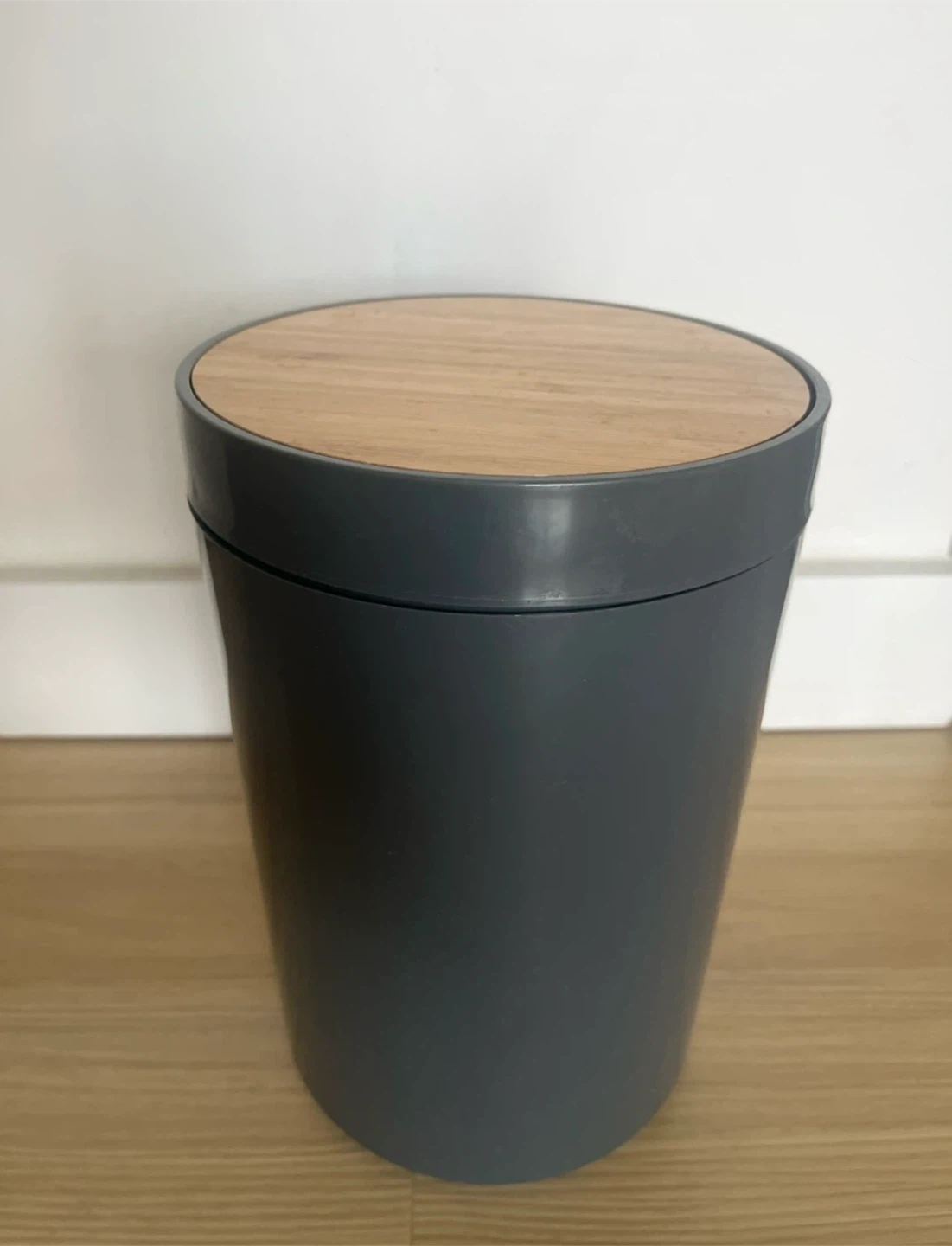 Gray waste bin with wood lid