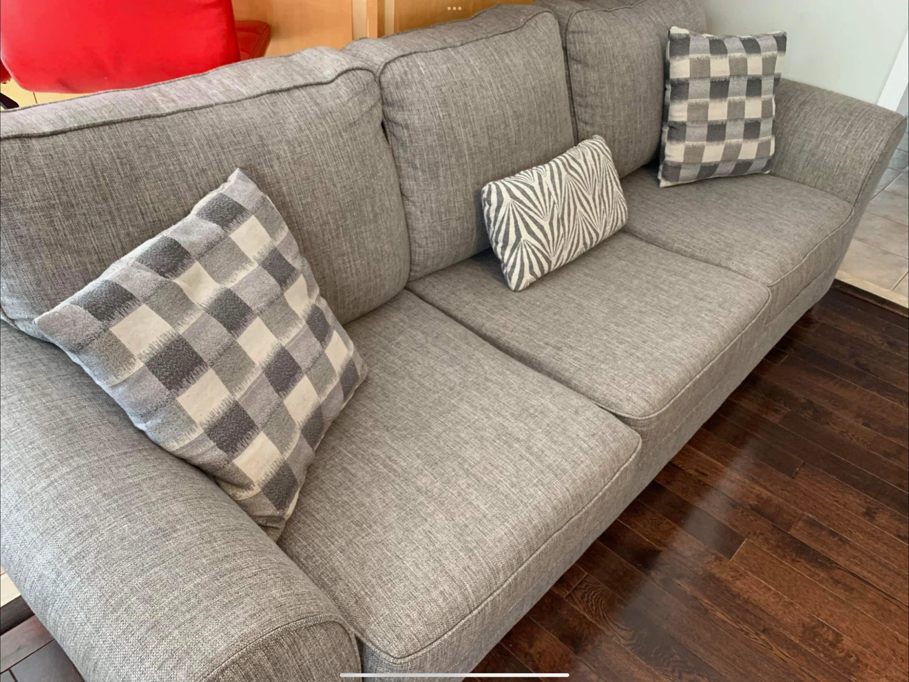 Grey fabric three seater sofa with accent pillows
