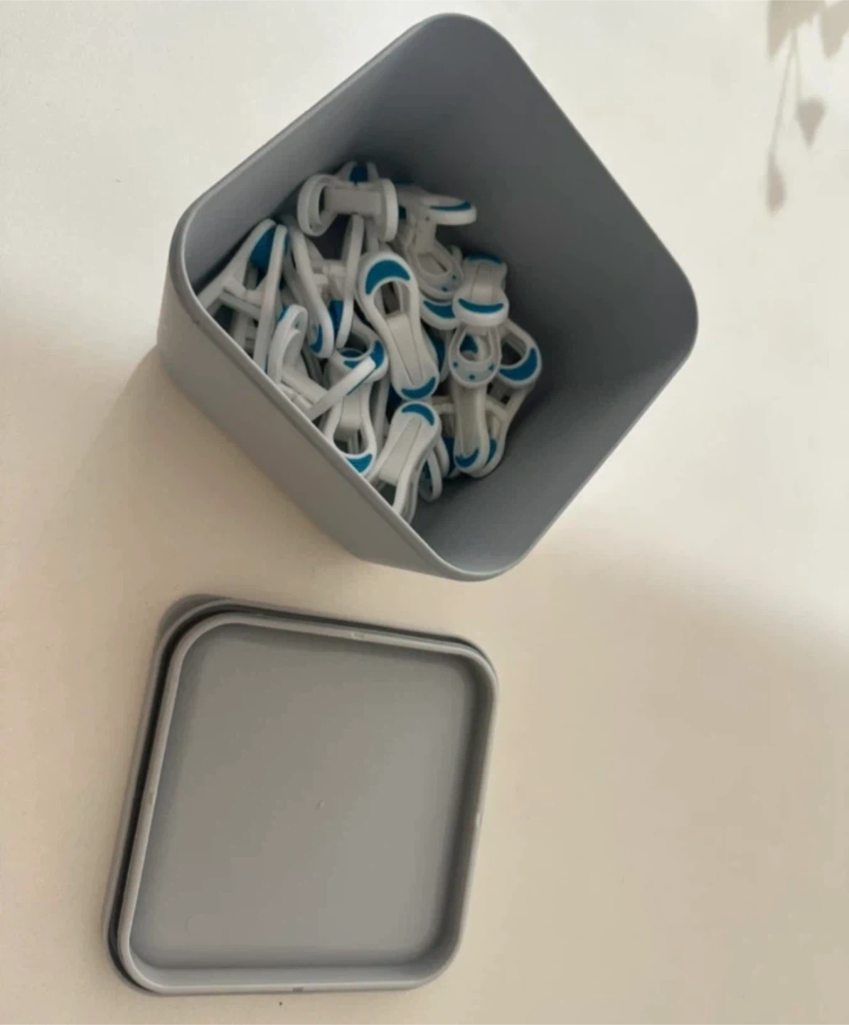 Grey storage container with clips