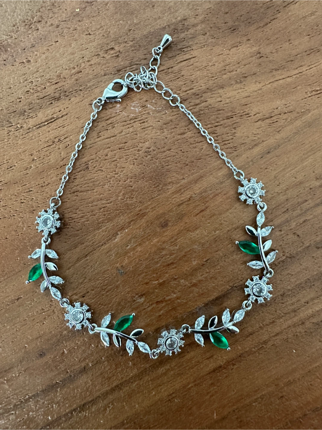Silver floral bracelet with green and white stones