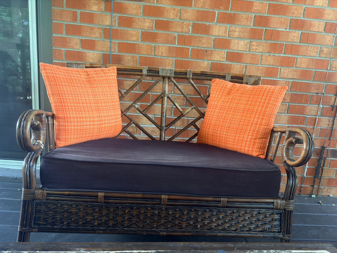 Wicker patio chair with floral cushion