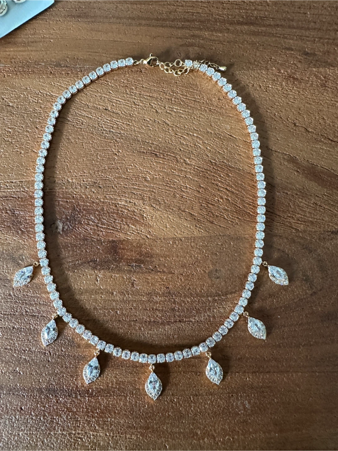 Gold tone tennis necklace with crystal drops