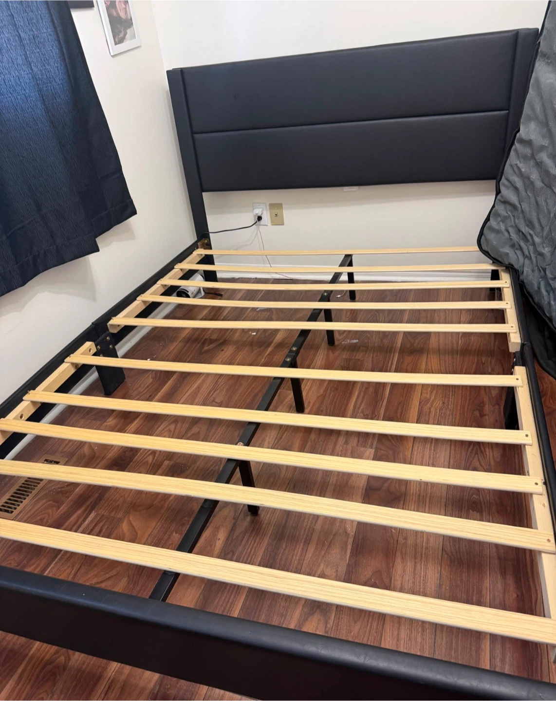 Black upholstered platform bed frame with headboard