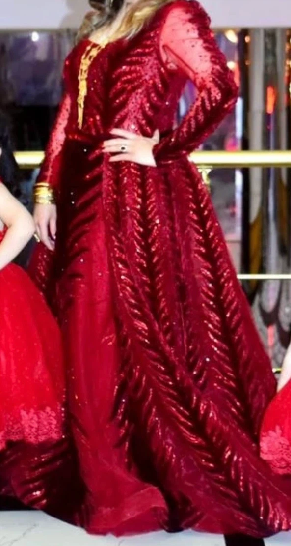 Red sequined gown with feather design