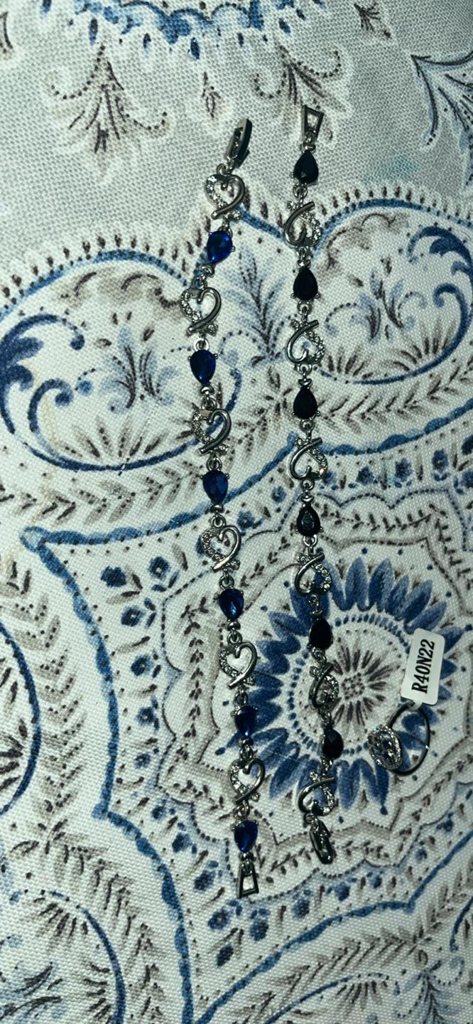 Silver-tone bracelets with blue and black heart-shaped stones