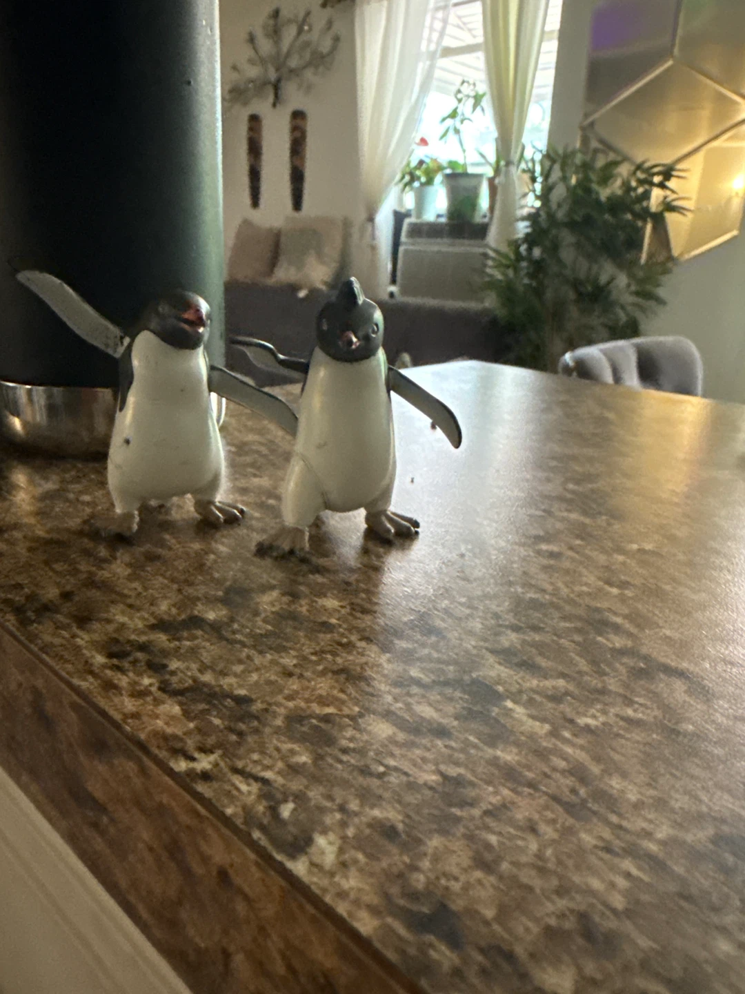 Two Penguin Figurines