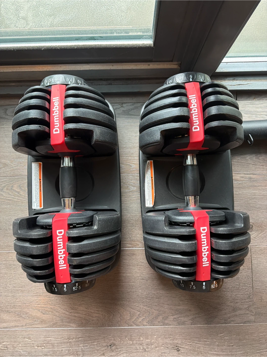 Adjustable dumbbell pair with bases