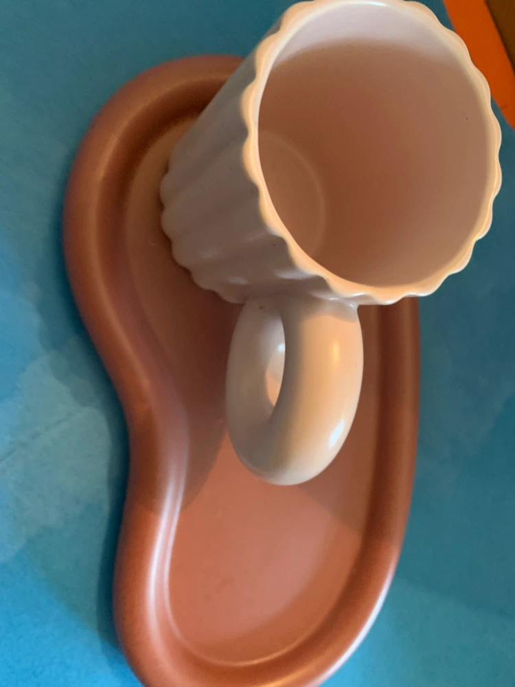 ceramic mug with brown bean shaped tray