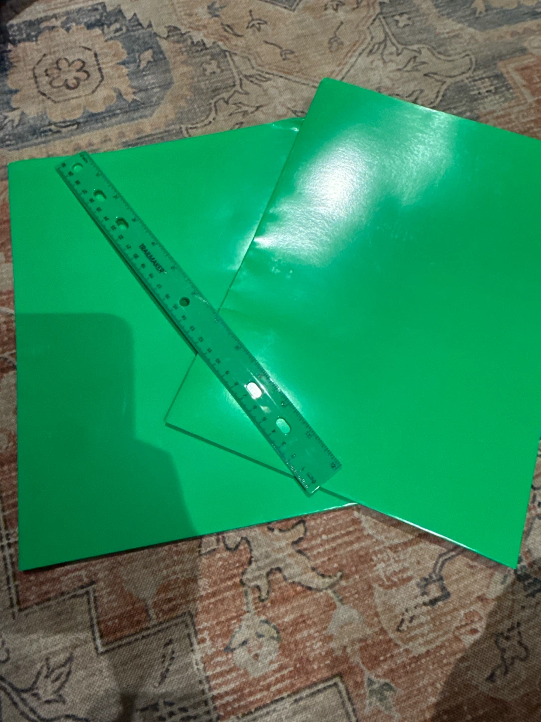 Two green binders with a  matching green ruler