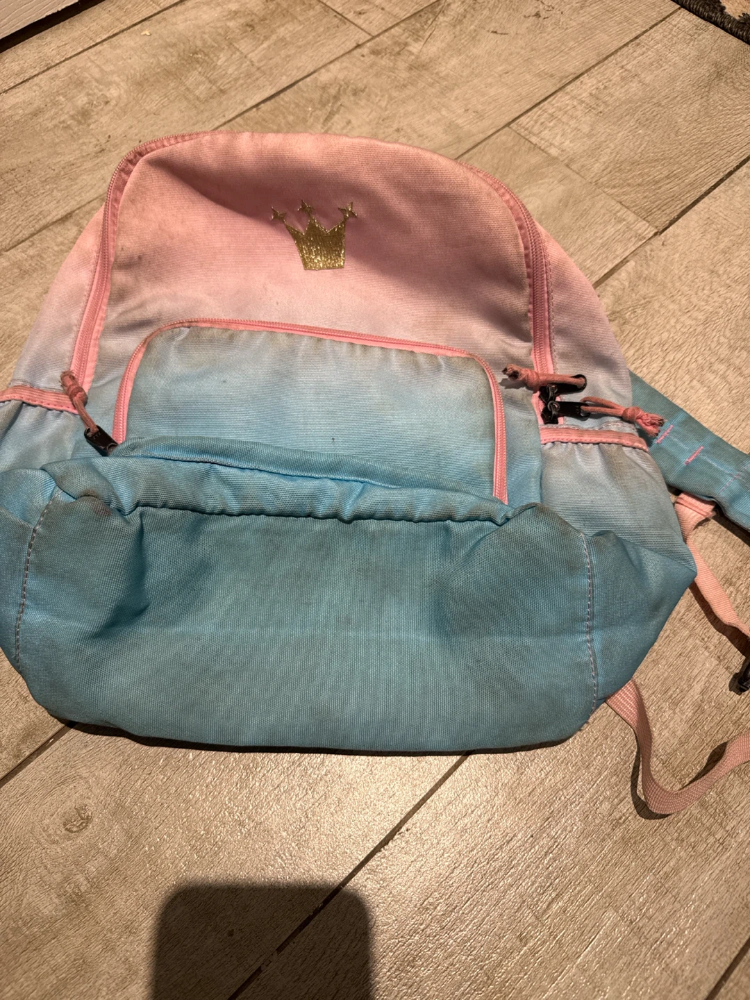 Pink and purple backpack with a gold crown.
