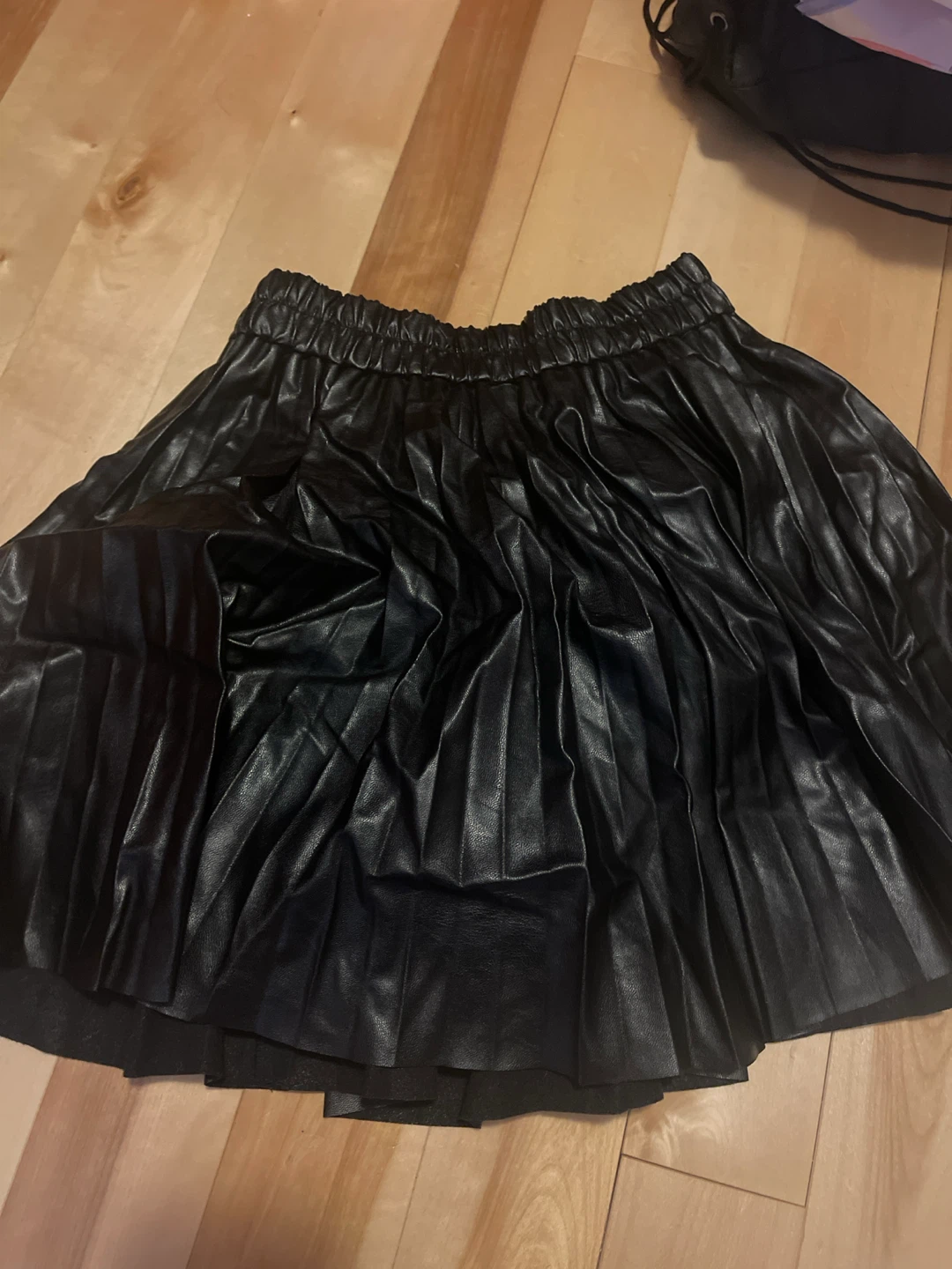 Black pleated faux leather skirt