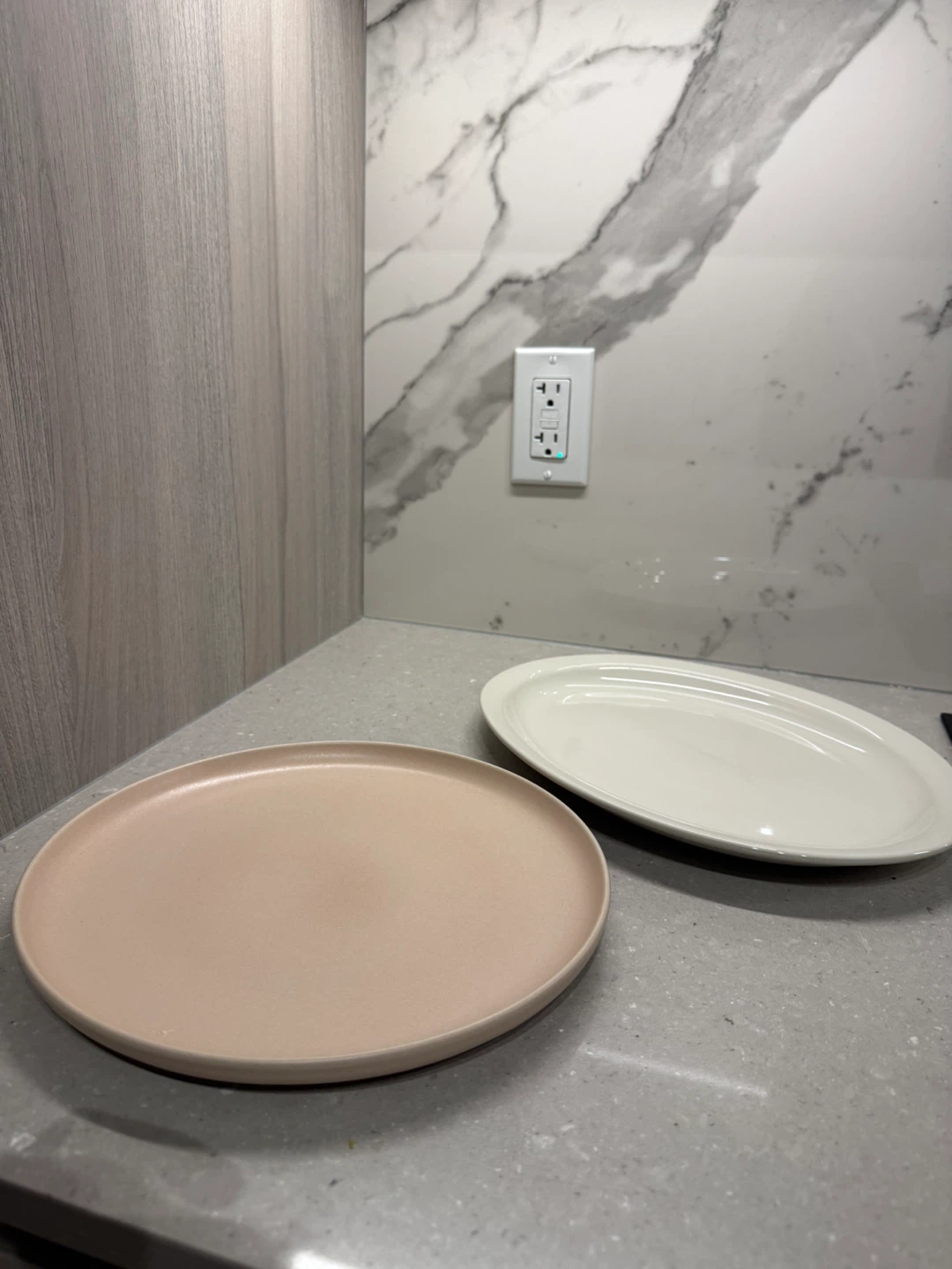 Two ceramic serving plates in pink and white