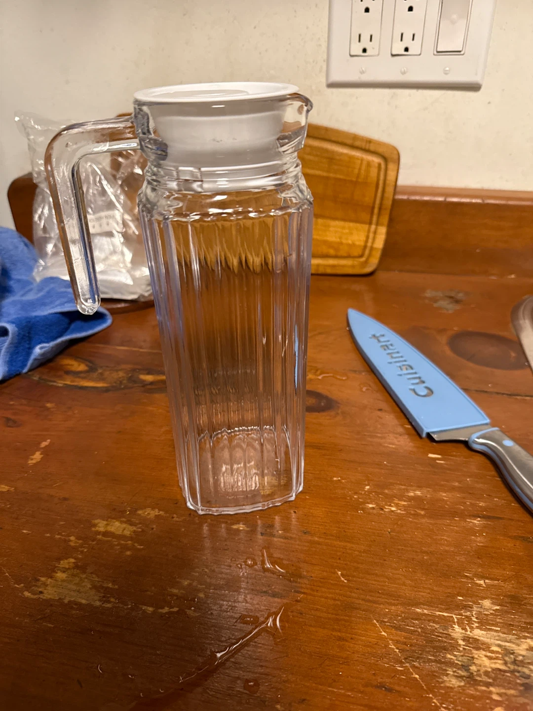 Clear glass pitcher with white lid