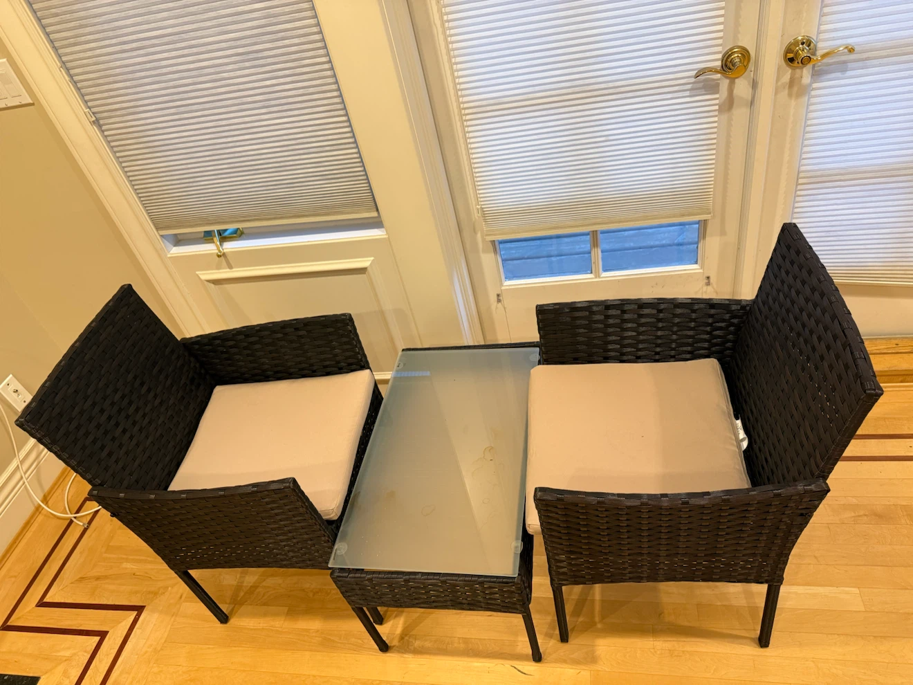 Wicker patio chairs and glass top table set