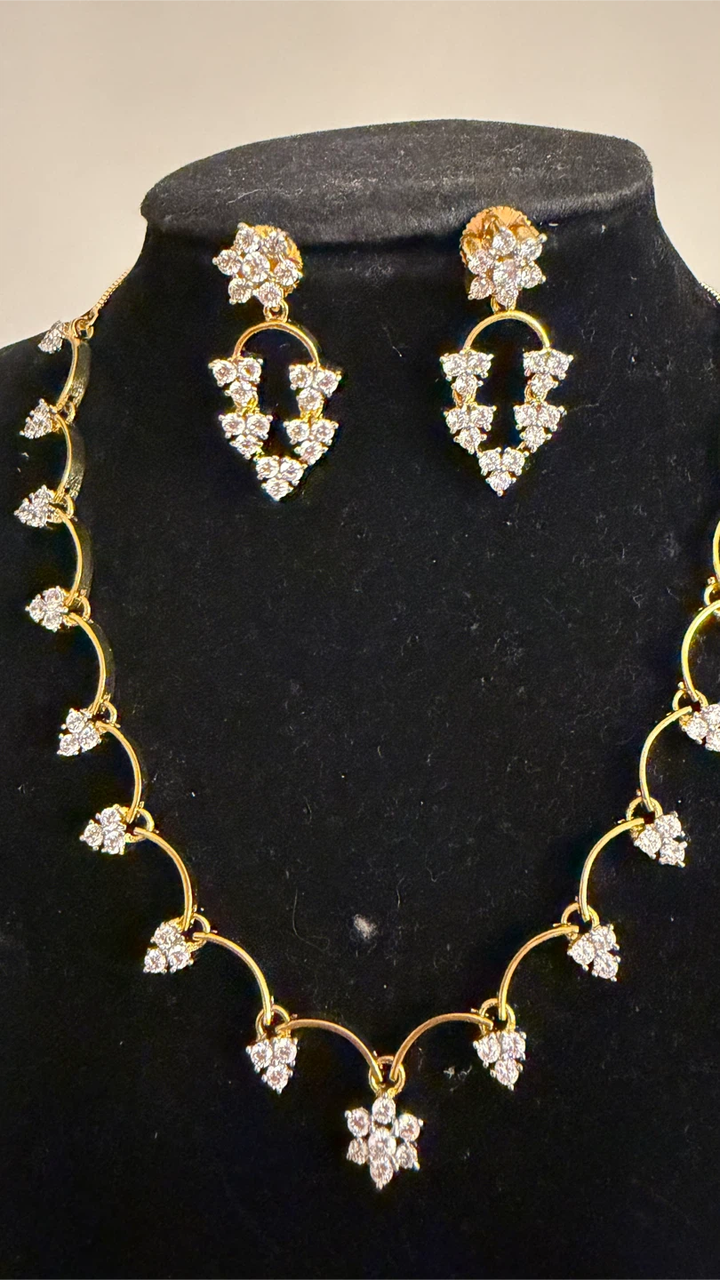 Gold-toned necklace and earring set with clear stones