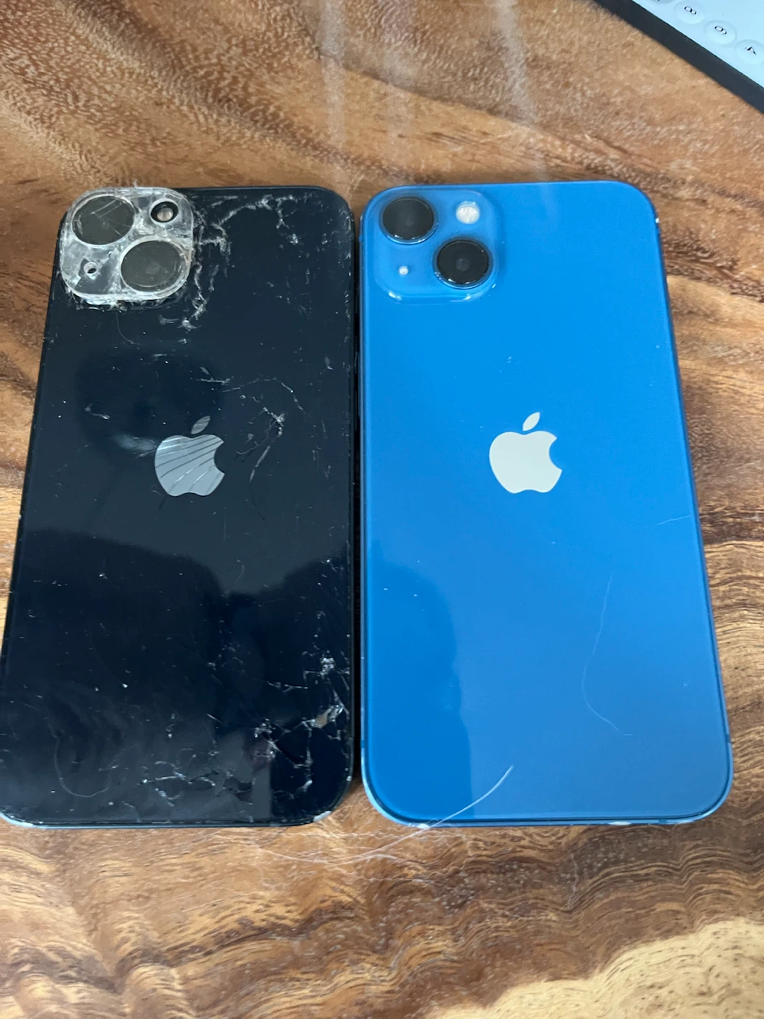 Black Apple iPhone 13 and Blue Apple iPhone 13