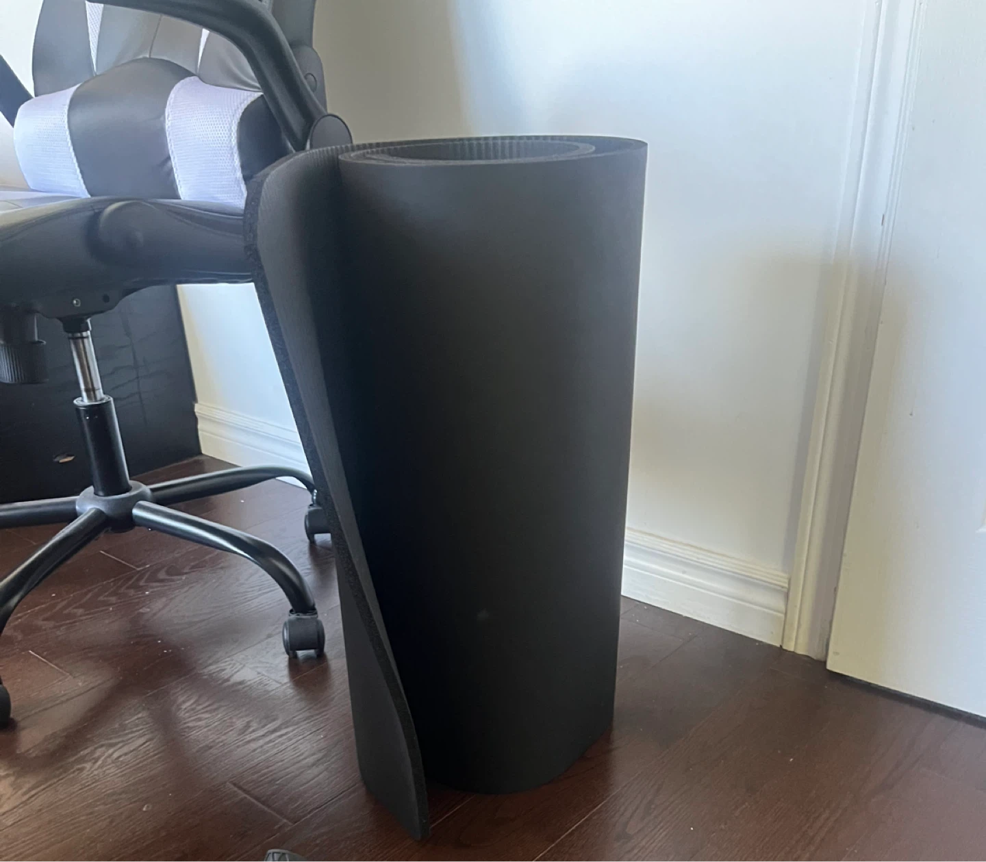 Black rolled foam yoga mat