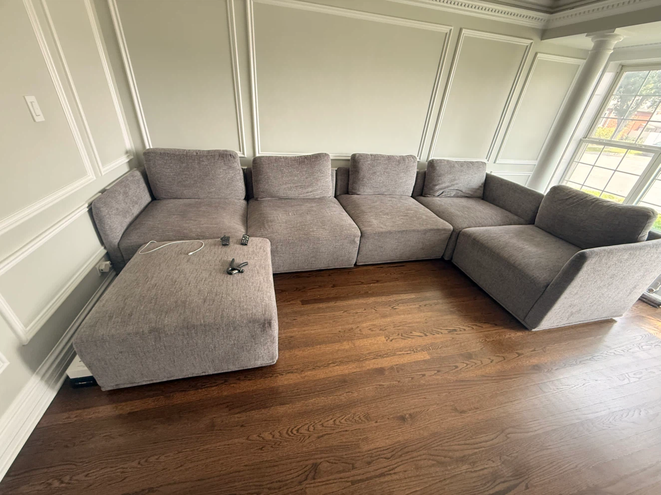 Large grey modular sectional sofa with ottoman