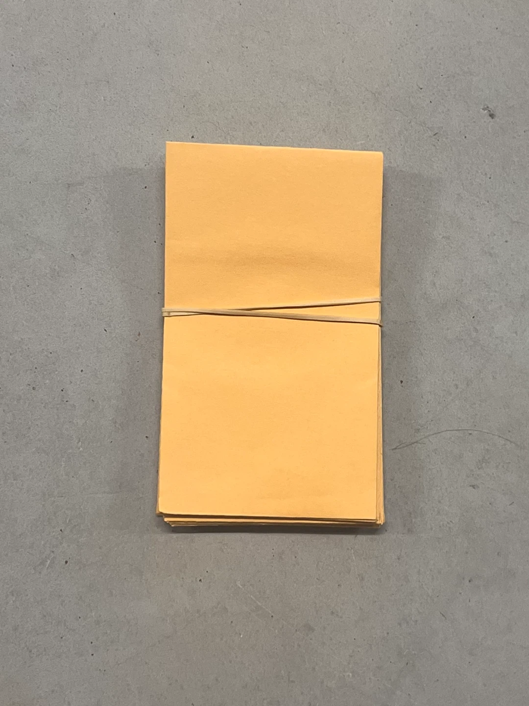 Stack of small yellow paper envelopes