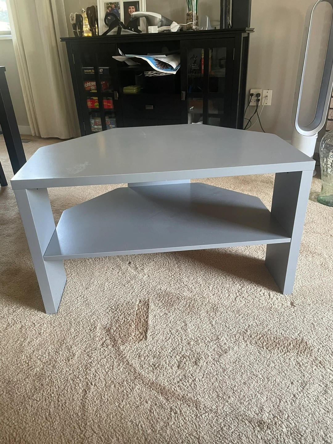 Grey corner TV stand with shelf