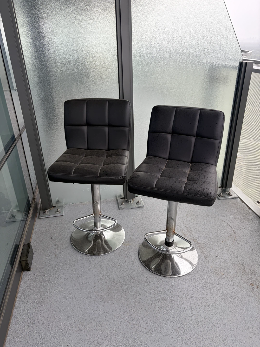 Set of two black faux leather swivel bar stools