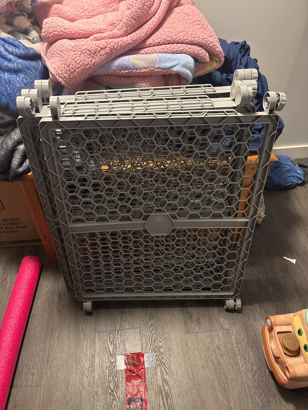 Grey plastic folding pet or baby gate