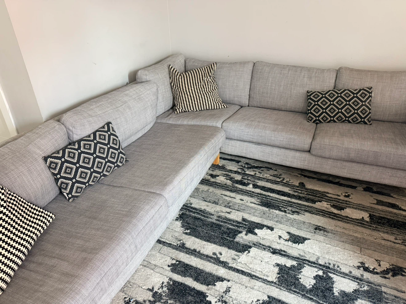 Grey sectional sofa with wooden legs