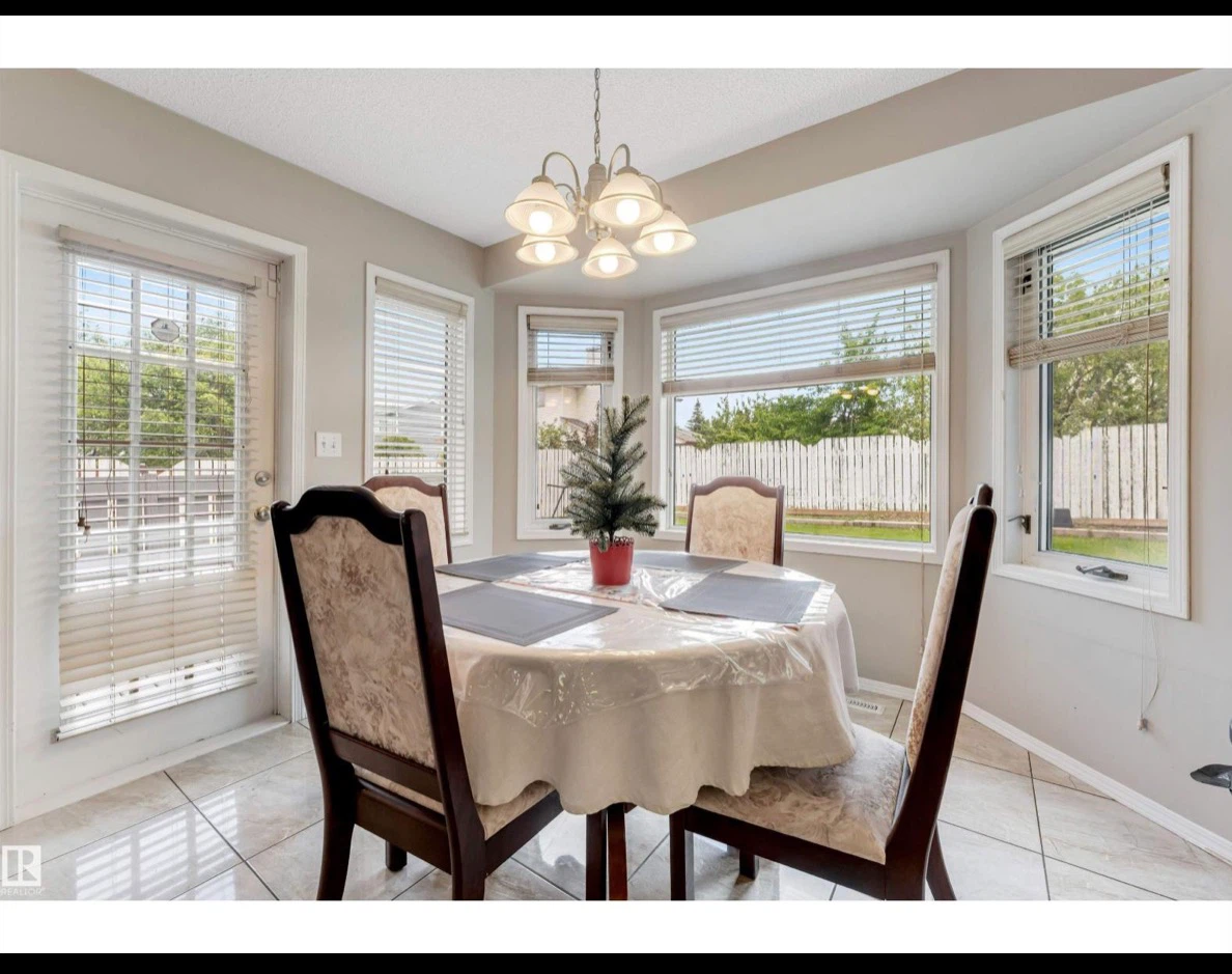 Round wooden dining table with four chairs