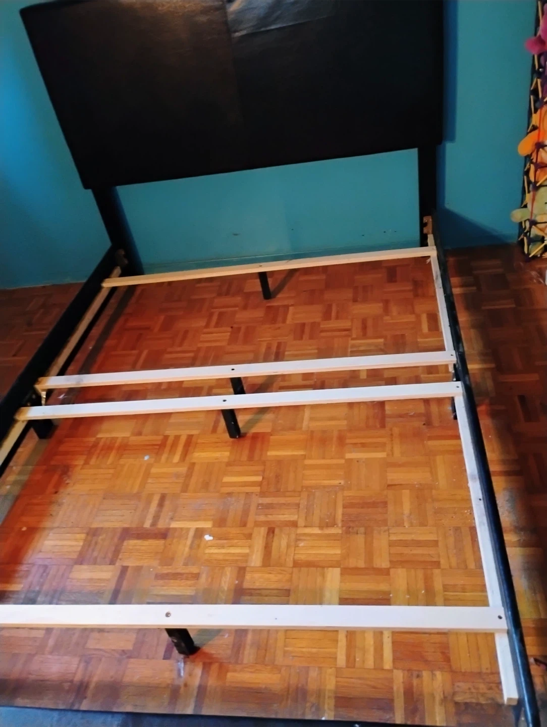 Black upholstered bed frame with headboard