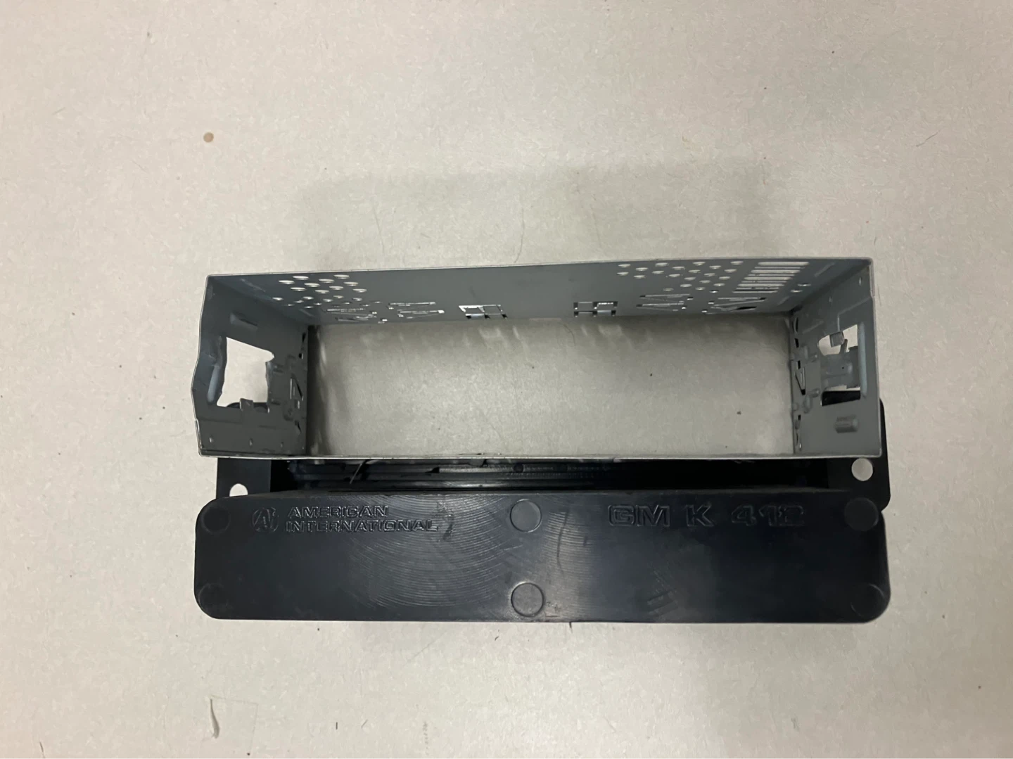 Black plastic and metal car stereo installation kit - photo 2