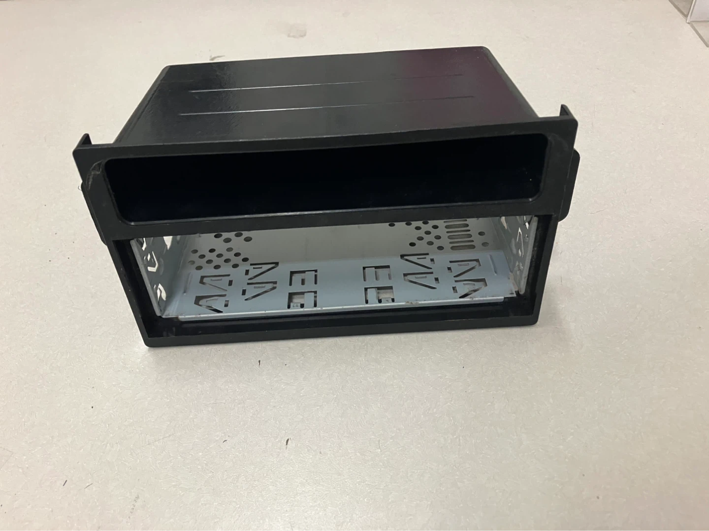Black plastic and metal car stereo installation kit