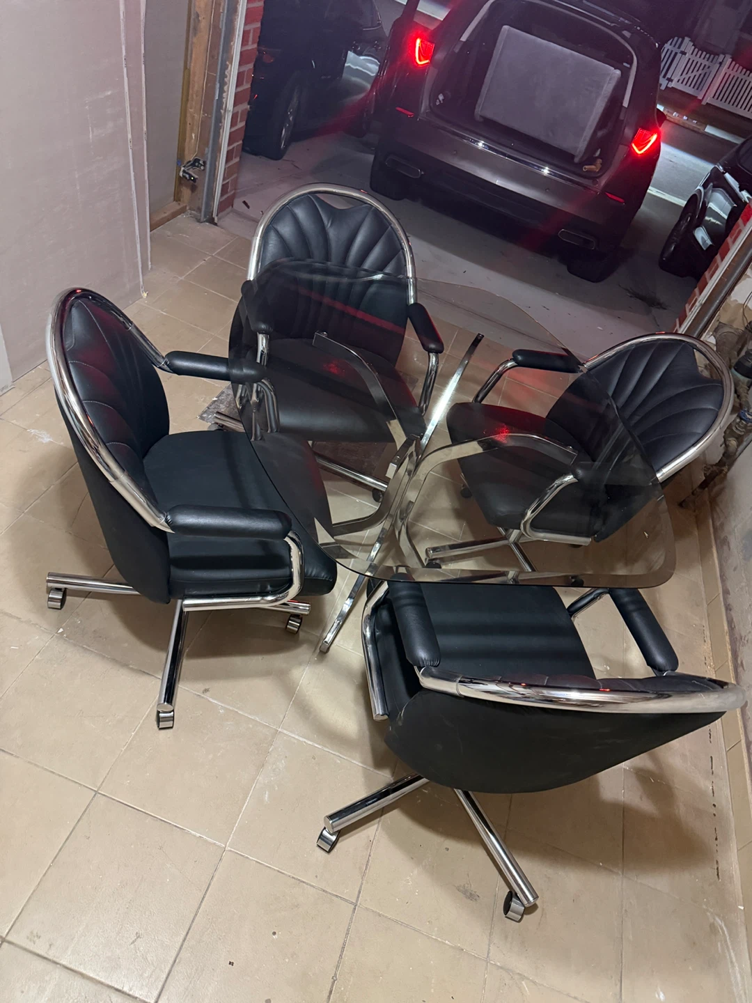 Black Rolling Caster Dining Chairs and Glass Table