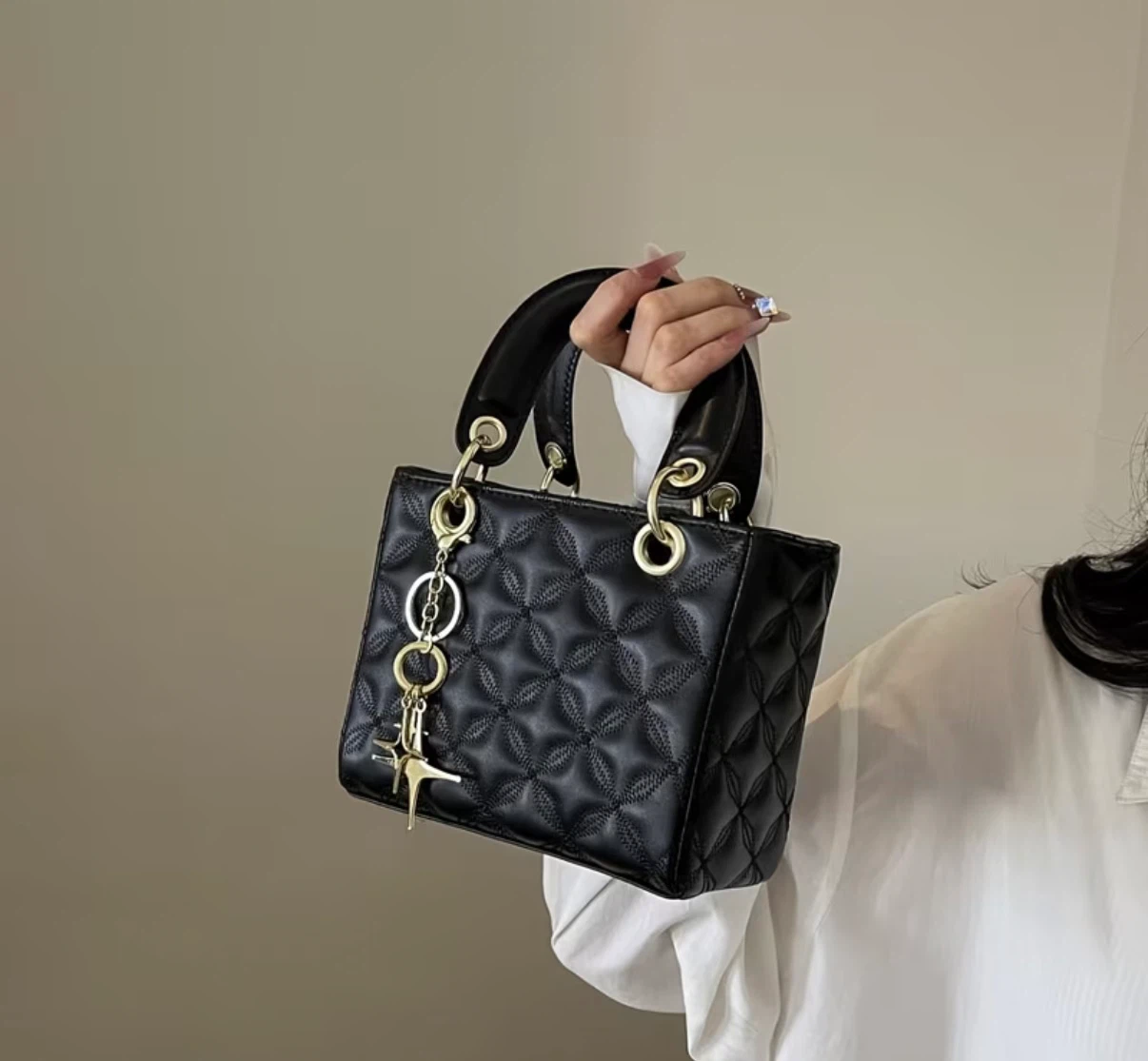 Black quilted handbag with gold hardware