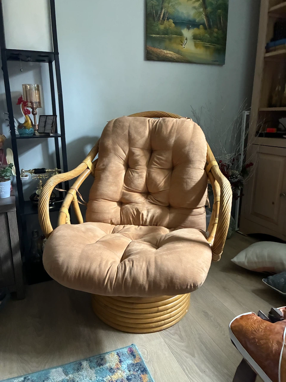 Rattan swivel rocker chair with tan cushion