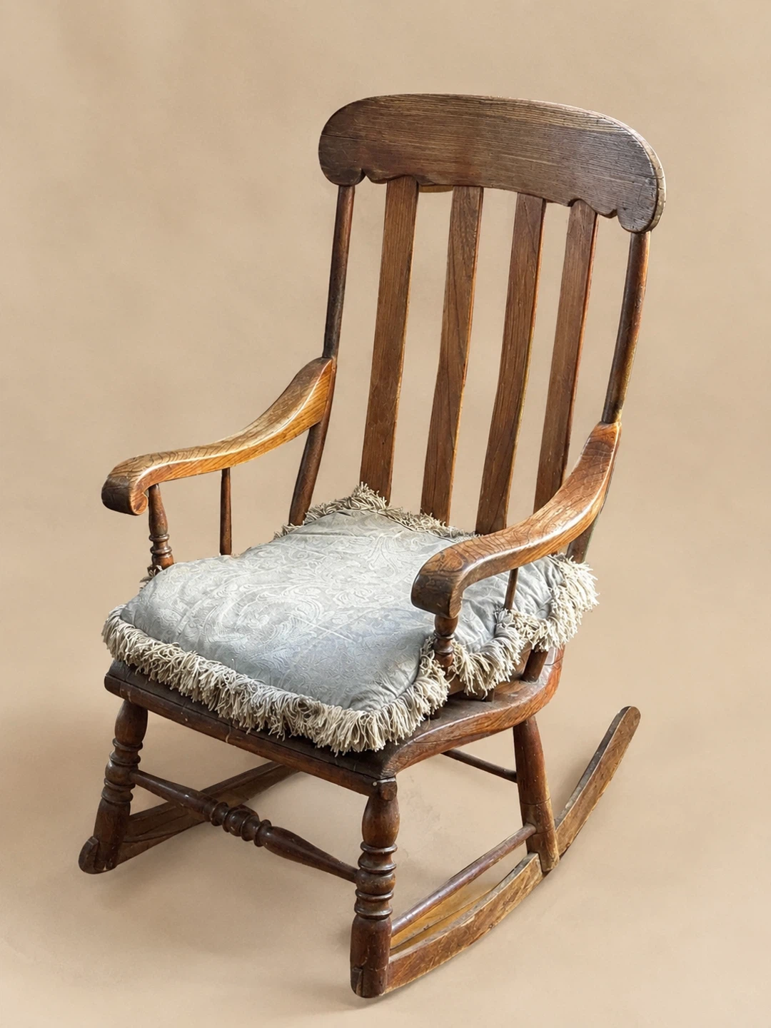 Vintage wooden rocking chair with seat cushion