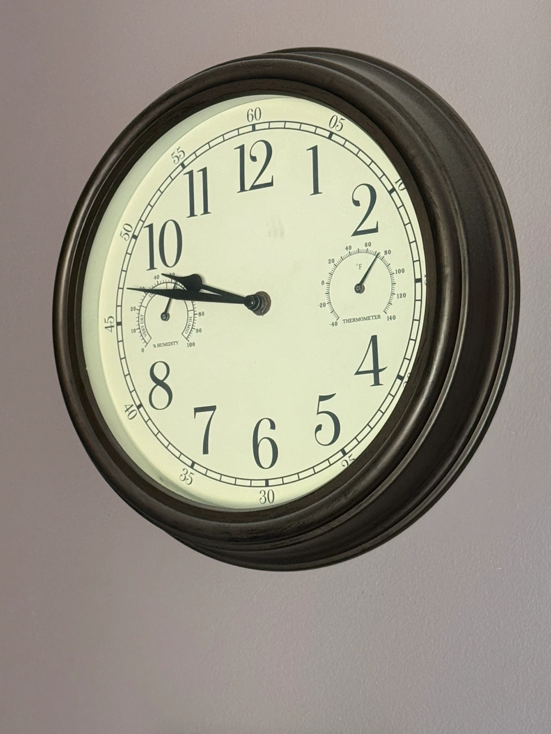 Dark brown wall clock with thermometer and hygrometer