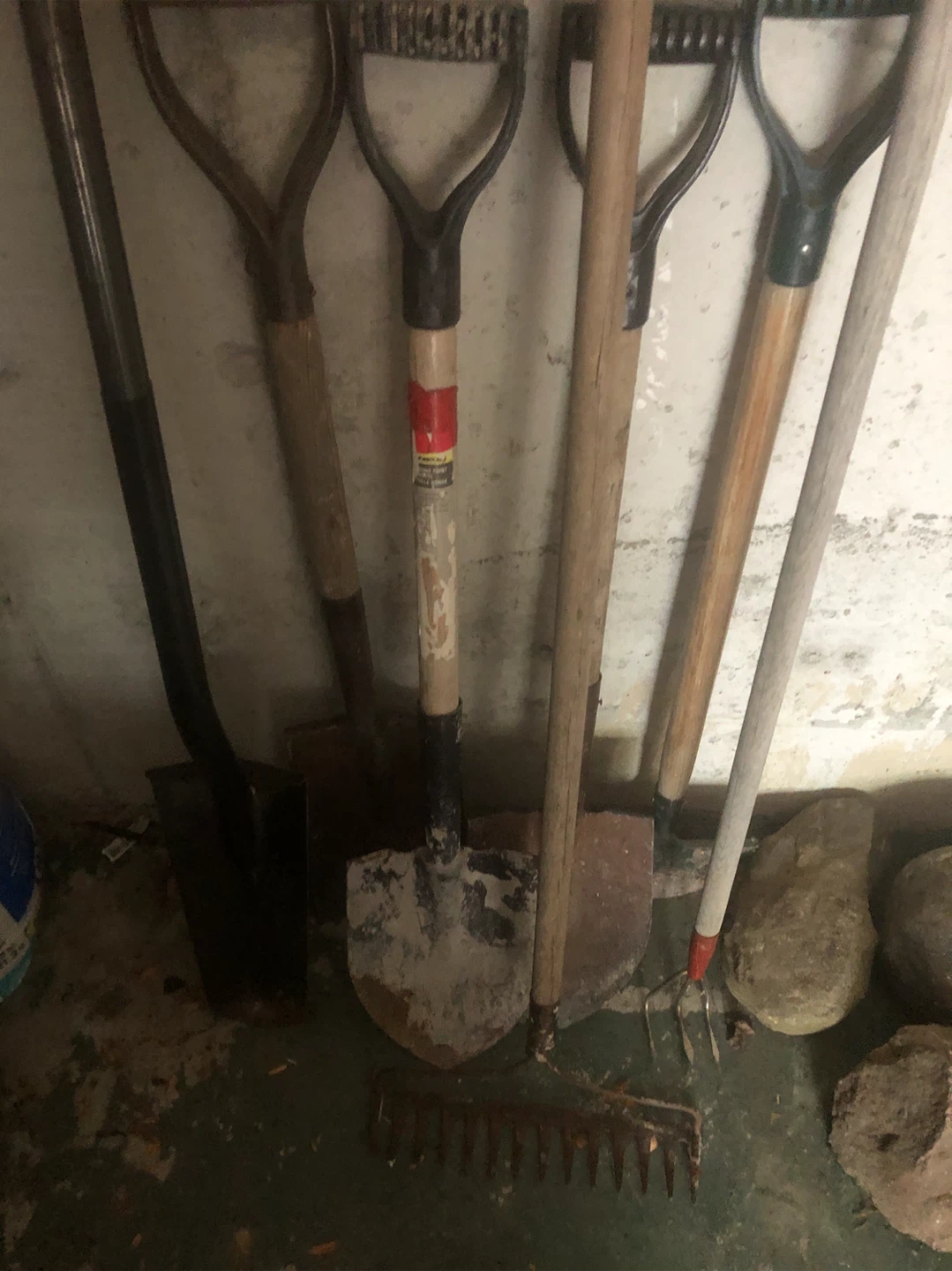Assortment of steel shovels spades racks